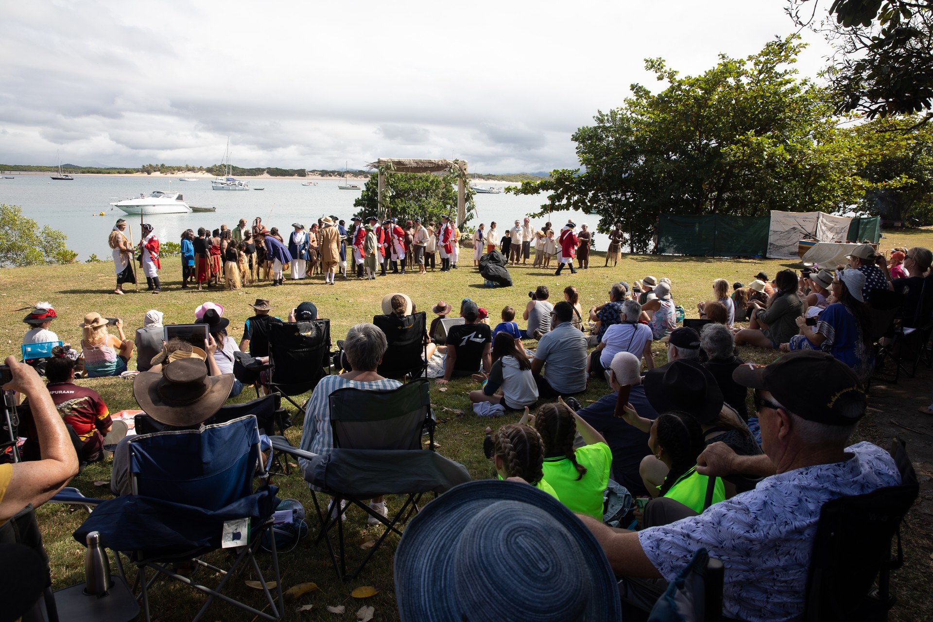 cast shot of performerrs at 62nd and 63rd re-enactment of Lt. James Cook's Landing at Waalmbal Birri (Endeavour River) and encounters with the Guugu Yimithirr Bama in 1770. The 250th anniversay of Australia's first contact, Cooktown, Queensland, Australia